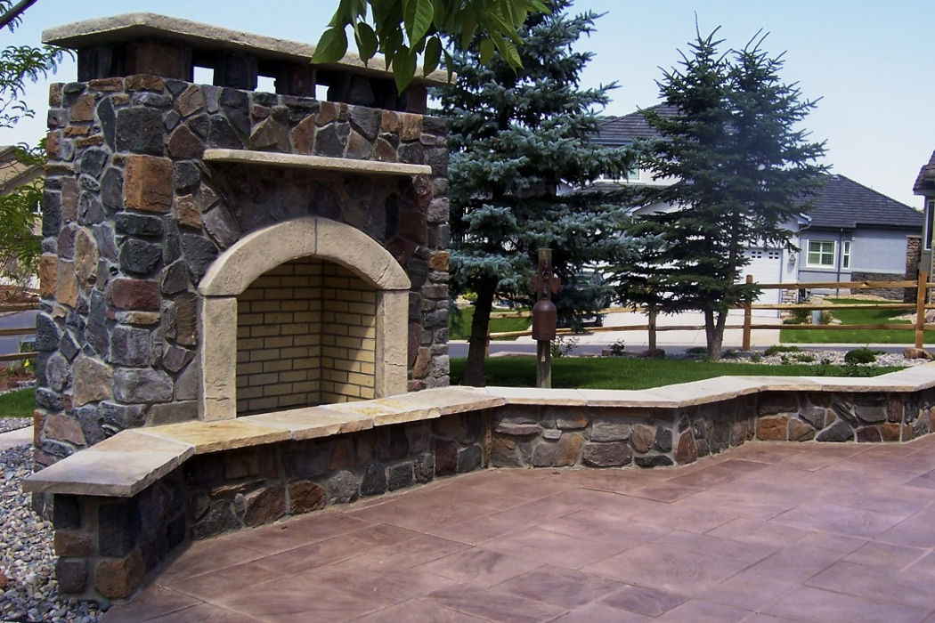 Outdoor stone fireplace, seating, and patio